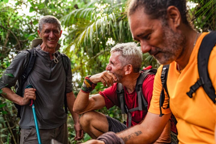 Three hikers having a break in wilderness.