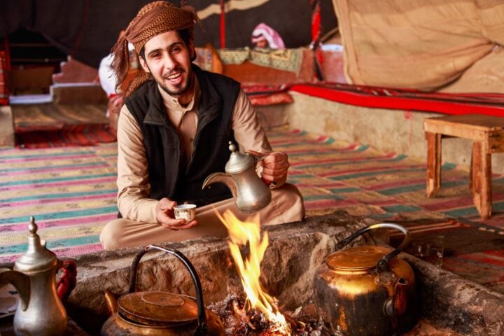 A Bedouin man serving Arabic coffee.
