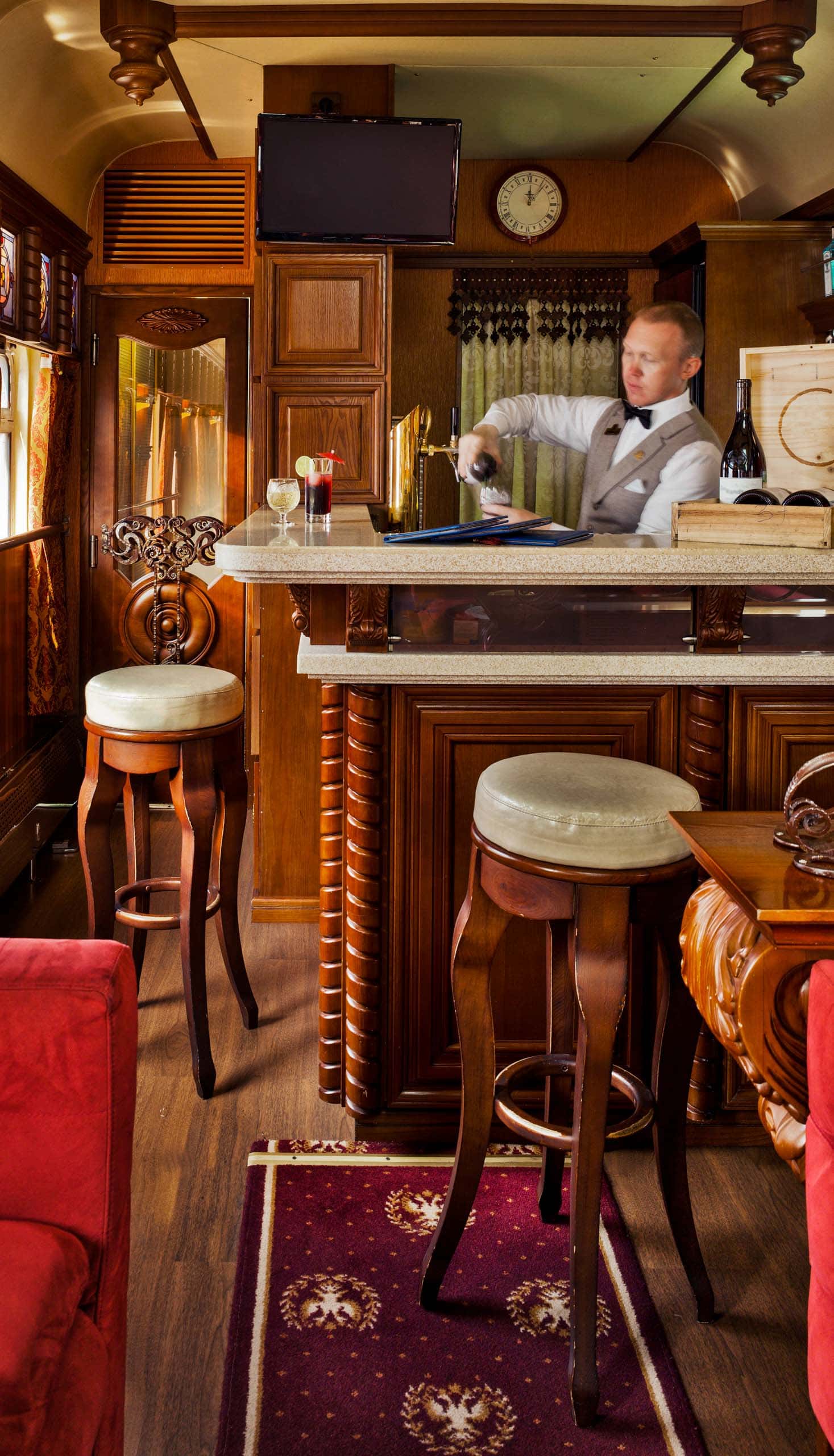 A bartender behind a bar in a train.