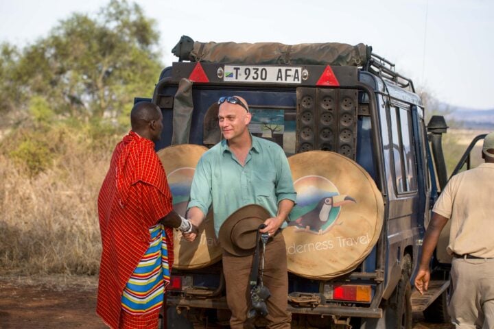A traveler shaking hands with a guide.