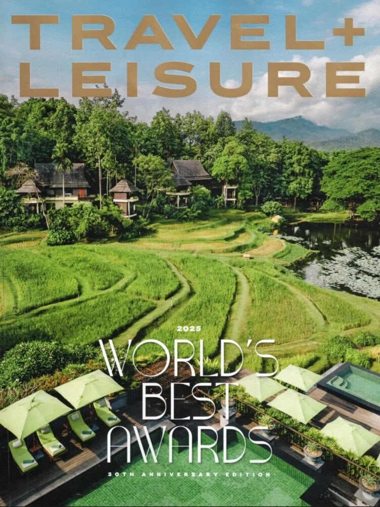 A magazine cover of Travel + Leisure featuring terraced rice fields, a pool with green lounge chairs, and a lush tropical landscape highlights 2025’s World’s Best Tour Operators under the "2025 World’s Best Awards" headline.
